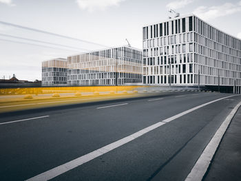 Road by city against sky