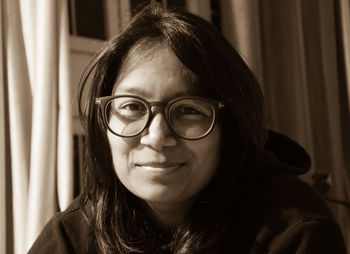 Close-up portrait of smiling woman at home