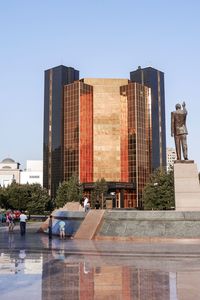 Statue of modern building against clear sky