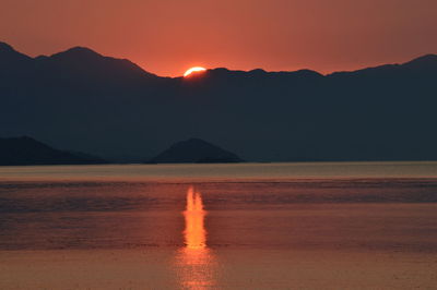 Scenic view of silhouette mountains against sky during sunset