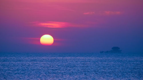 Scenic view of sea against romantic sky at sunset