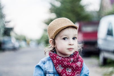 Close-up portrait of cute girl on road