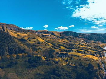 Scenic view of mountains against blue sky