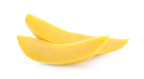 Close-up of yellow fruit against white background
