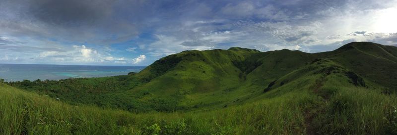 Panoramic view of sea and mountains against sky