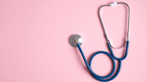 High angle view of pink ring against colored background