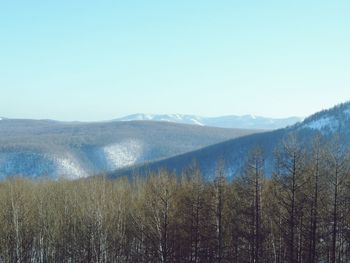 Scenic view of mountains against clear blue sky