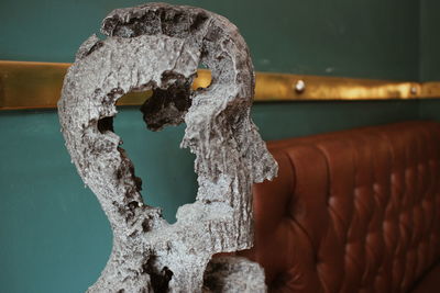 Close-up of rusty metal on wall against building