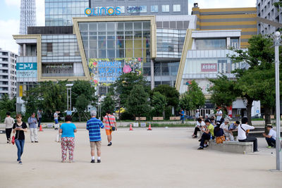 Rear view of people looking at city