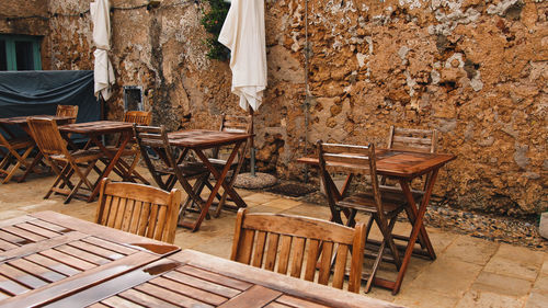 Empty chairs and tables in yard