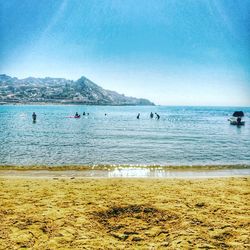 Scenic view of beach against blue sky