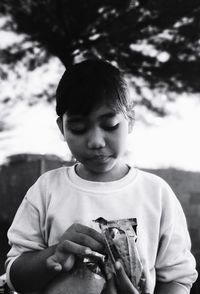 Portrait of cute boy holding outdoors