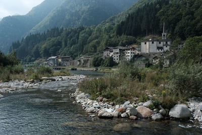 Scenic view of river amidst buildings