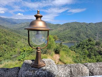 Street light and mountains against sky