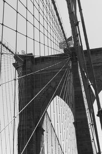 Low angle view of suspension bridge against sky