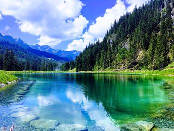 Scenic view of lake and mountains against sky