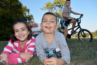 Portrait of siblings at park