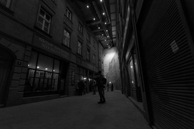 Man walking in illuminated city at night