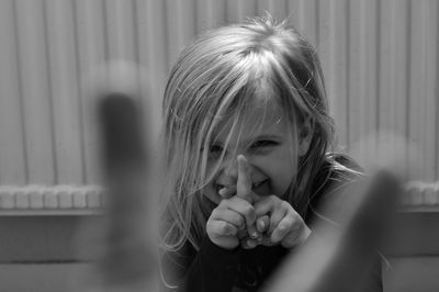 Portrait of smiling girl gesturing at home