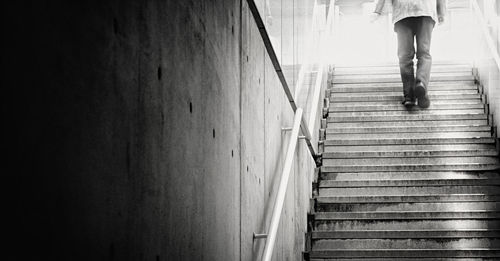 Low section of man moving up on steps