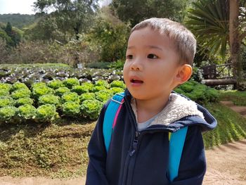 Close-up of thoughtful boy standing at park