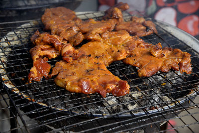 High angle view of meat on barbecue grill