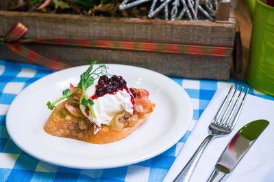 Poached egg on bruschetta with microgreens and caramelized onions