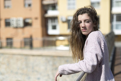 Portrait of young woman in city