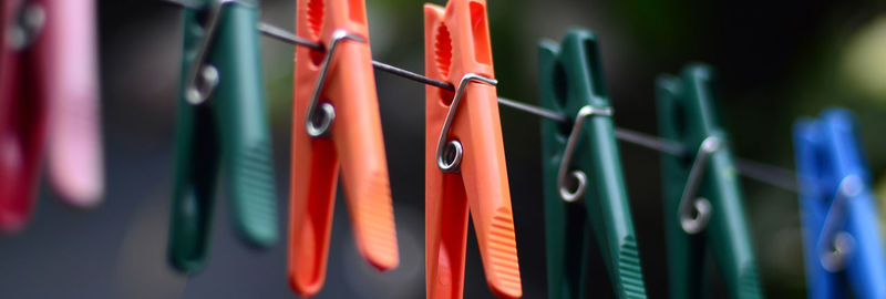 Close-up of clothespins on clothesline