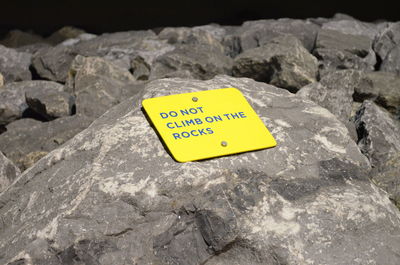 Close-up of yellow text on rock