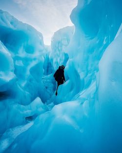 Mid distance view of person amidst fox glacier during winter