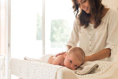 Mother massaging son at home