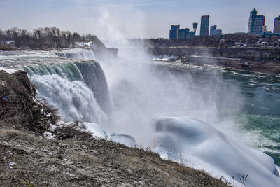 Scenic view of waterfall in city