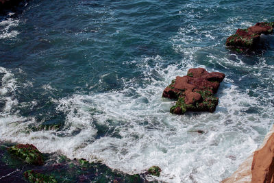 High angle view of rocks in sea