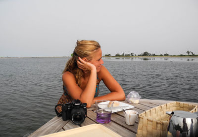 Rear view of woman sitting in water