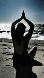 Close-up of mannequin on beach against clear sky