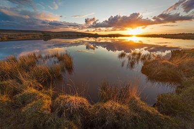 Scenic view of lake against sky during sunset