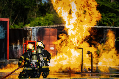 Firefighters are conducting fire drills by spraying water to extinguish the raging fire.