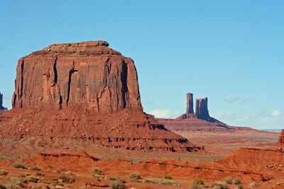 Rock formations on landscape against blue sky