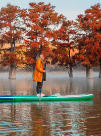 Rear view of man kayaking in lake