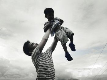 Father with son against sky