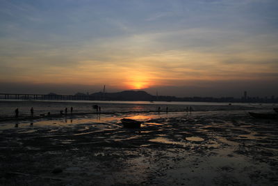 Scenic view of beach against sky during sunset