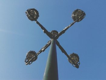 Low angle view of ferris wheel against blue sky