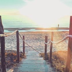 Pier on sea during sunset