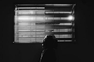 Woman standing by window