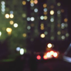 Defocused image of illuminated city at night