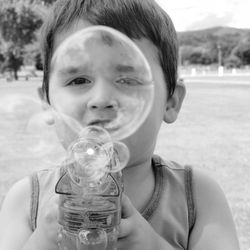 Portrait of boy playing with bubble gun