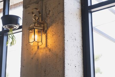 Low angle view of electric lamp on building