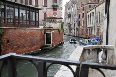 Canal amidst buildings in city