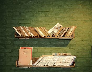 High angle view of books on table against wall